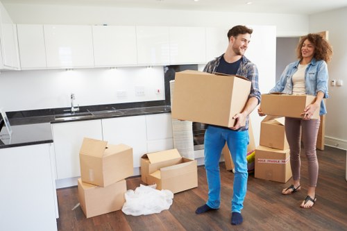 Moving crew loading household items carefully into a removals van
