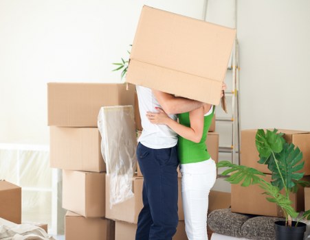 Local movers handling boxes and furniture in a Harringay flat move